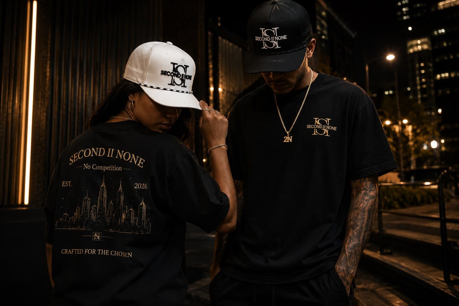 Two models wearing the Second II None Shreveport II Dallas tee and signature caps