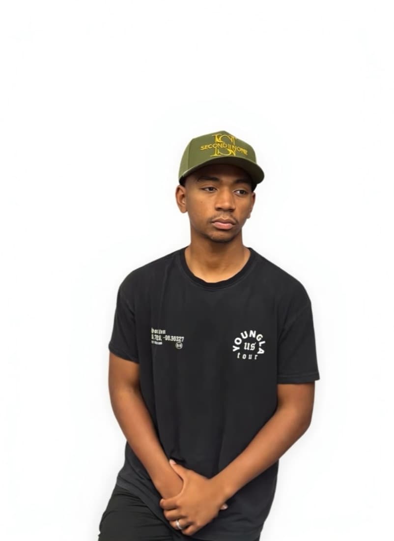 Person in a black T-shirt wearing an olive Second II None cap