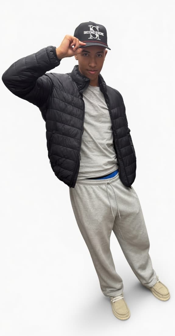 Person in a black puffer jacket tipping a black Second II None cap