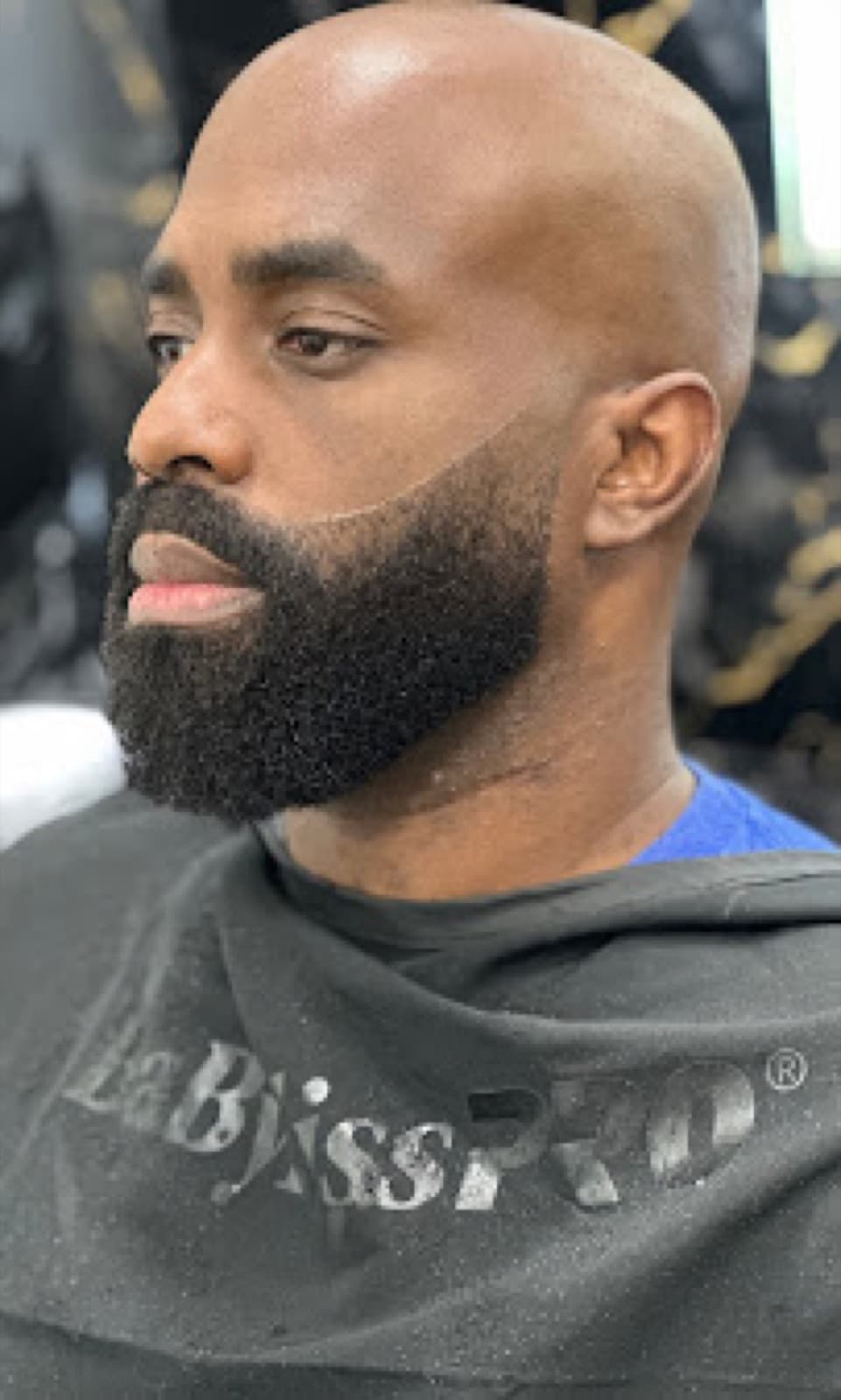 Clean bald head with a precisely shaped beard