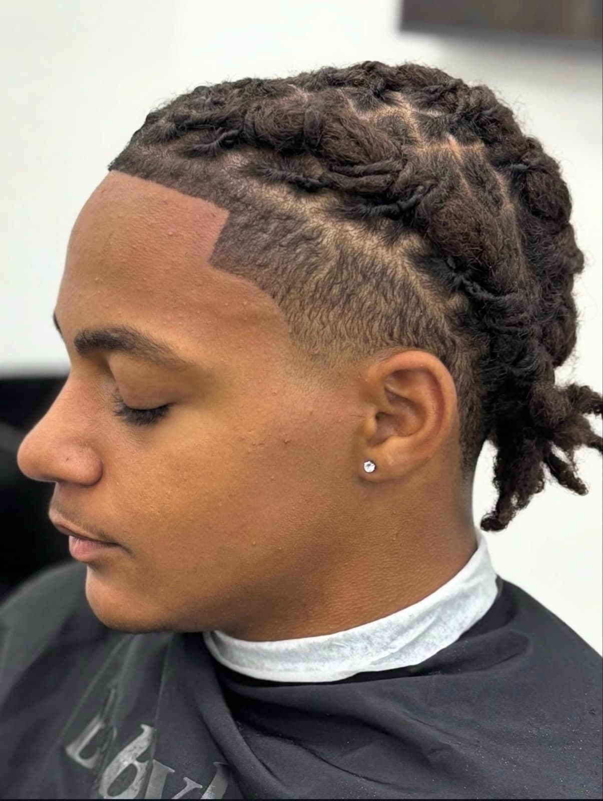 Locs with a taper fade and crisp line-up