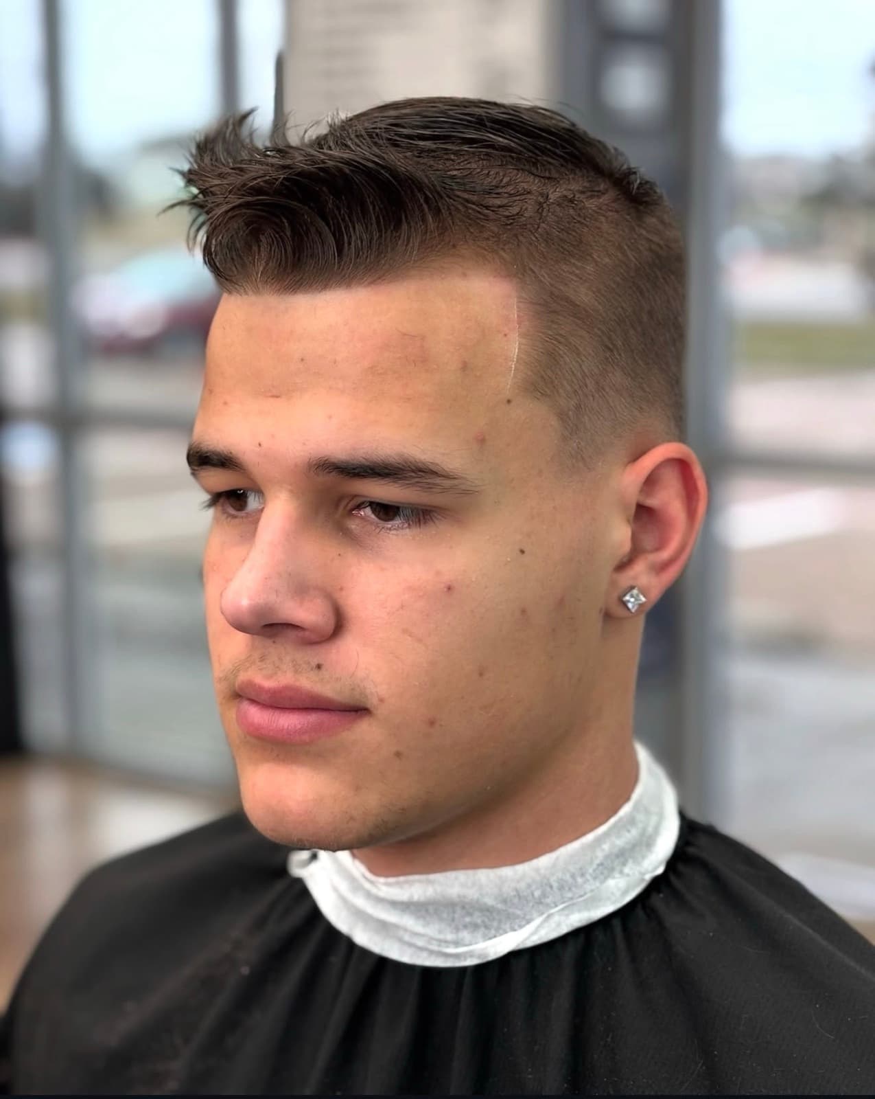 Textured quiff finished over a skin fade