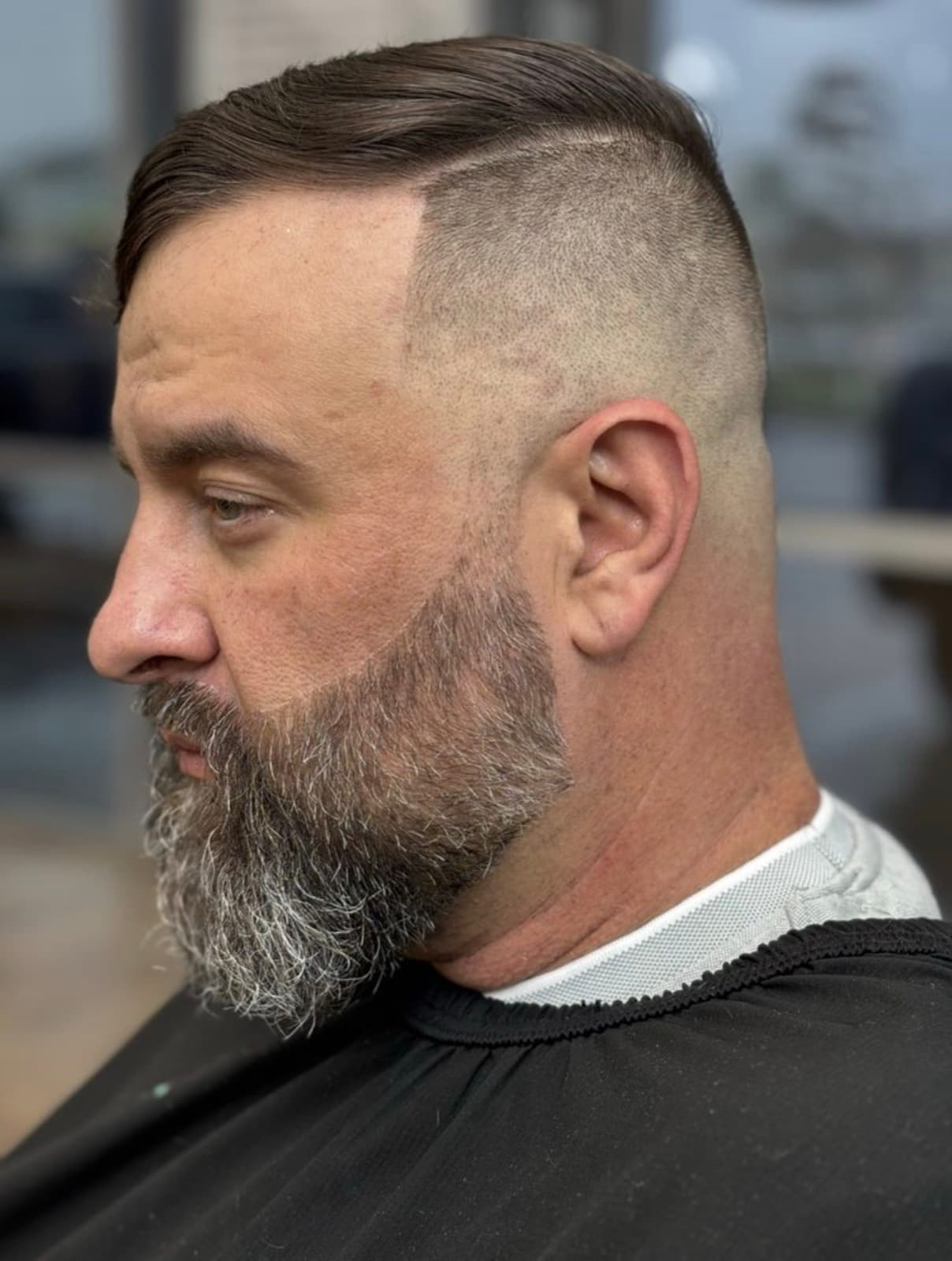 Slicked-back style over a high fade